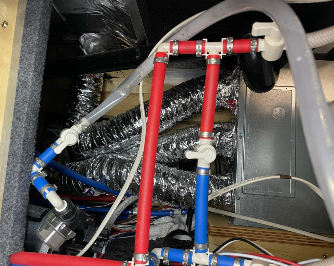 Mobile RV plumbing repair technician servicing water lines on an RV in Stuart, Florida